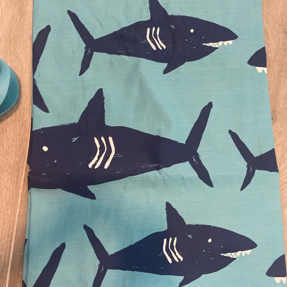 Pillowfort brand shark shower curtain and matching whale faucet cover.